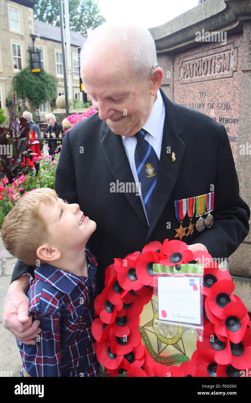 Hayfield, High Peak, Derbyshire, UK. 15 August 2015. Second World War veteran and President of Hayfield Royal British Legion, Albert Knowles with his youngest great-grandson, Cayden Knowles, 7, at the VJ Day 70th anniversary service at Hayfield War Memorial. A Royal British Legion member for 70 years, Albert is approaching his 100th birthday. The Far East veteran served in Burma, Malaya, India and Singapore, reaching the rank of Captain. He became President of the Royal British Legion Hayfield Branch in 1950 and is believed to be the longest serving Branch President in the UK. © Matthew Taylor Stock Photo