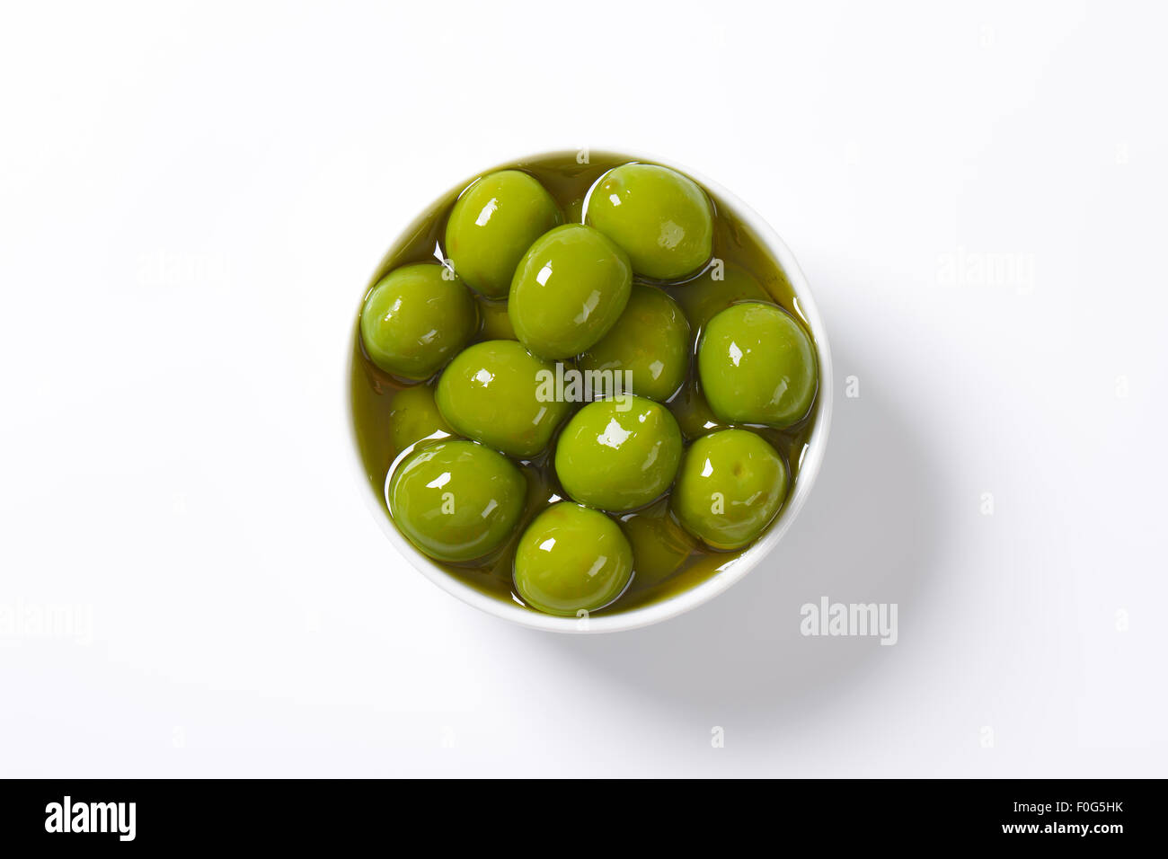 Bowl of green olives in oil Stock Photo Alamy