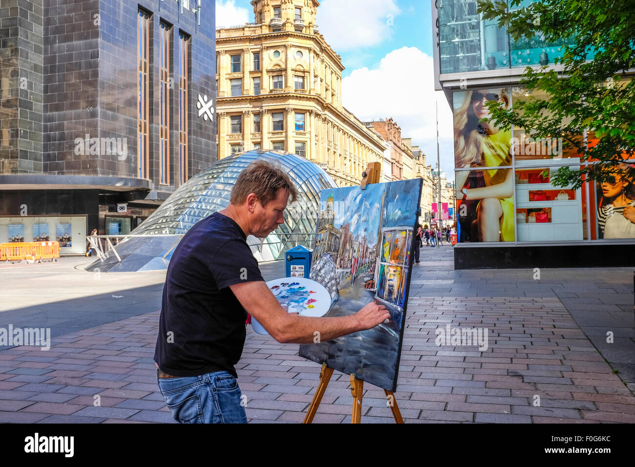 Glasgow, Scotland, UK. 15th Aug, 2015. Almost 150 artists came to Glasgow to take part in the "Rapid Painter" art competition with the aim being to make a painting capturing the spirit of Glasgow city, completed in 1 day. The artists attracted a lot of curiosity and interest from tourists and locals, when they set up in various locations about the city. All the completed works will go on exhibition on Sunday 16 August at the Royal Concert Hall, Sauchiehall Street, Glasgow when many of the paintings will be for sale. Credit:  Findlay/Alamy Live News Stock Photo