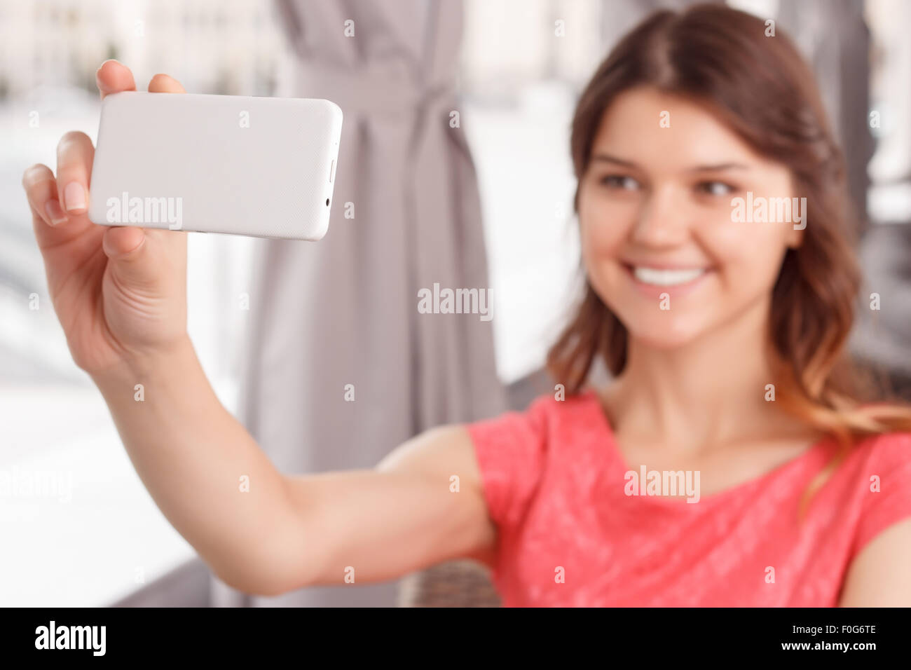Smiling girl doing selfie in cafe Stock Photo - Alamy