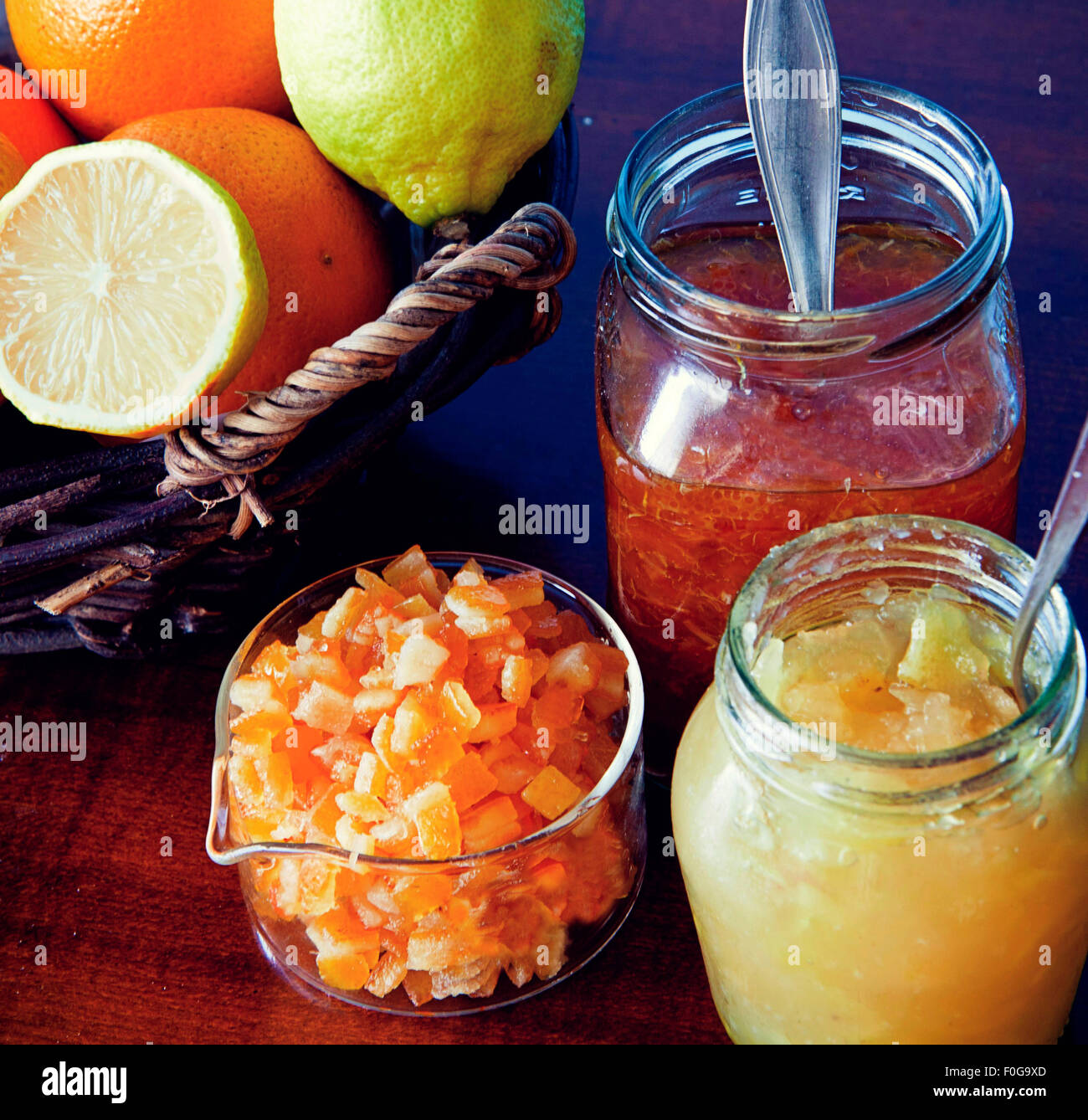 breakfast table, fresh citrus fruits,opened jars of jams and marmalade