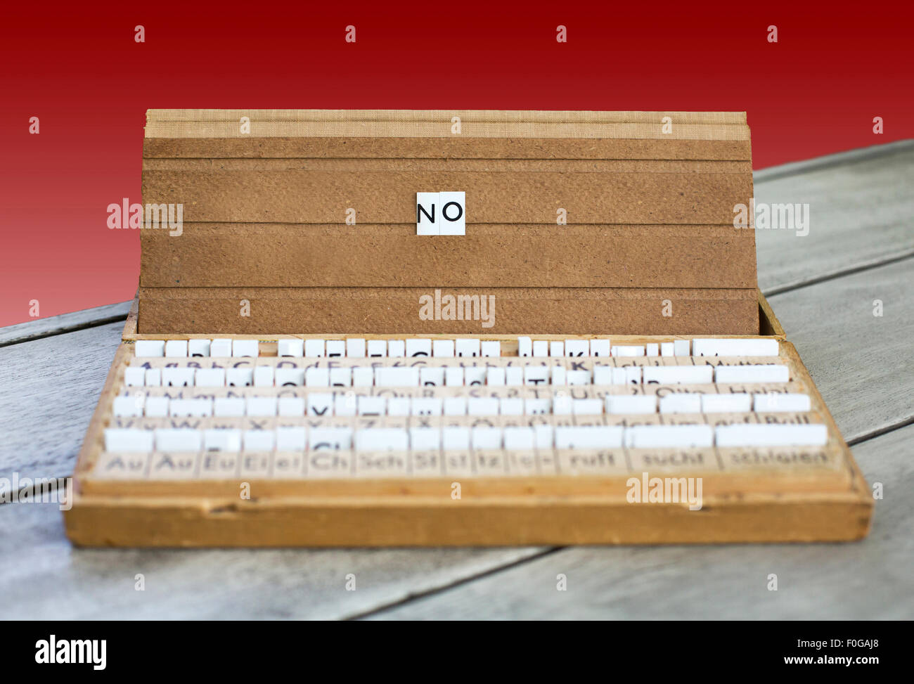 the word 'no' on an old school letter box with a red background Stock Photo