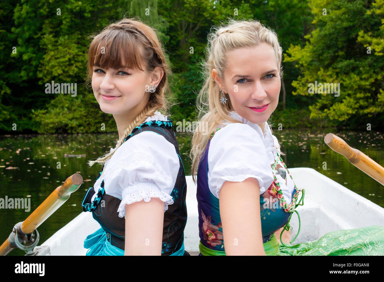 two women with dirndl in a rowing boat Stock Photo - Alamy