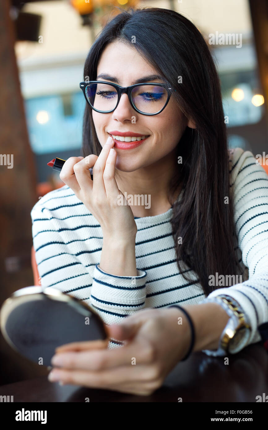 Portrait of young beautiful woman making up her face. Stock Photo