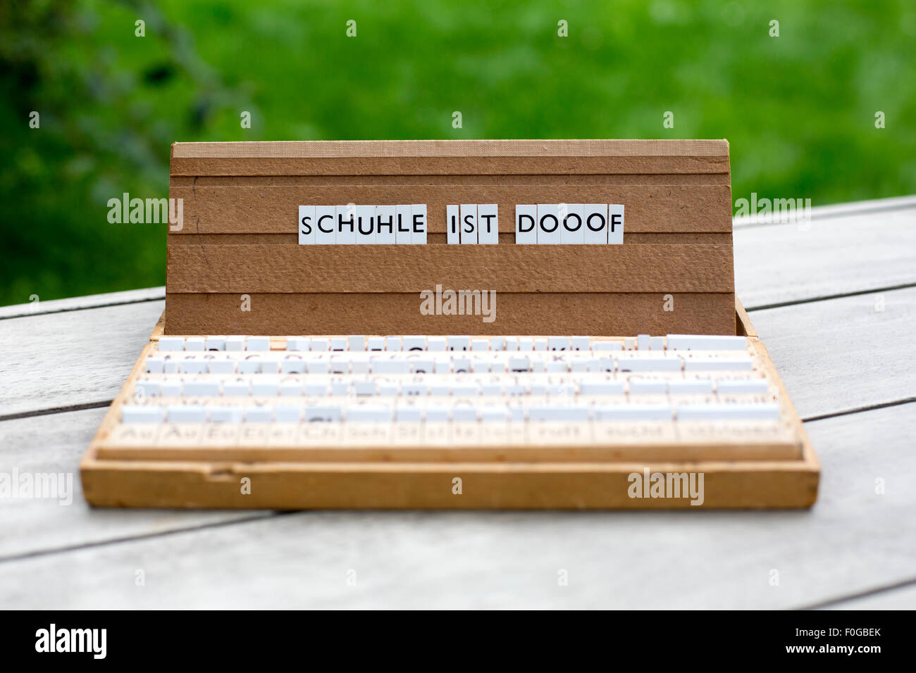 a letterbox with the german text: 'Schuhle ist dooof' (school is stupid, misspelled) Stock Photo