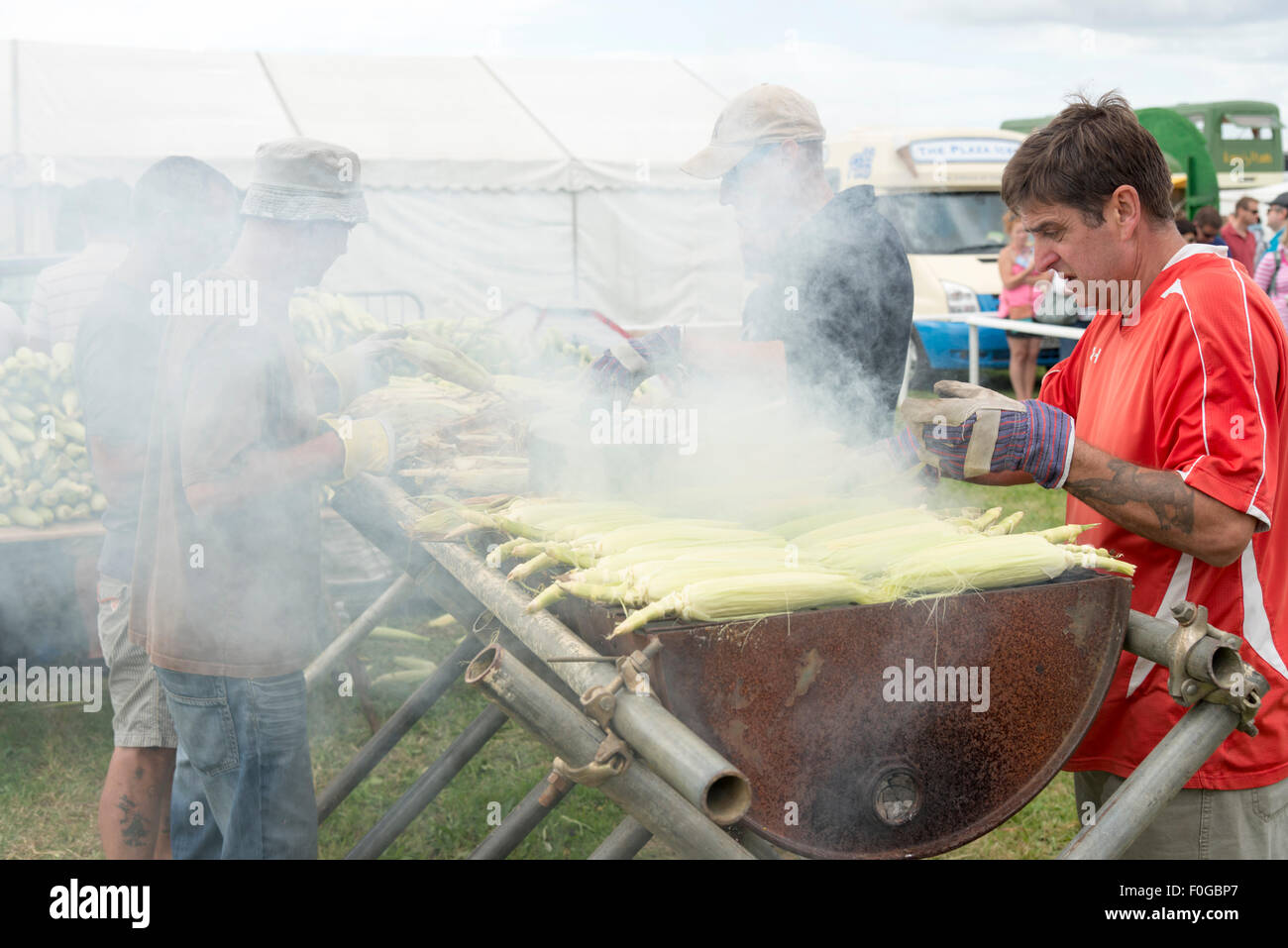 Newchurch, Isle of Wight, UK. 15th Aug, 2015. Volunteers BBQ 2000 cobs of sweetcorn at the Isle of Wight Garlic Festival, in aid of the Isle of Wight Asthma Swim Charity (to help children with asthma swim). The festival is the Island’s biggest summer food fair and entertainment event. The festival celebrates the famous garlic grown on the Island and other local foods, crafts, music and family entertainment. Credit: Julian Eales/Alamy Live News Stock Photo