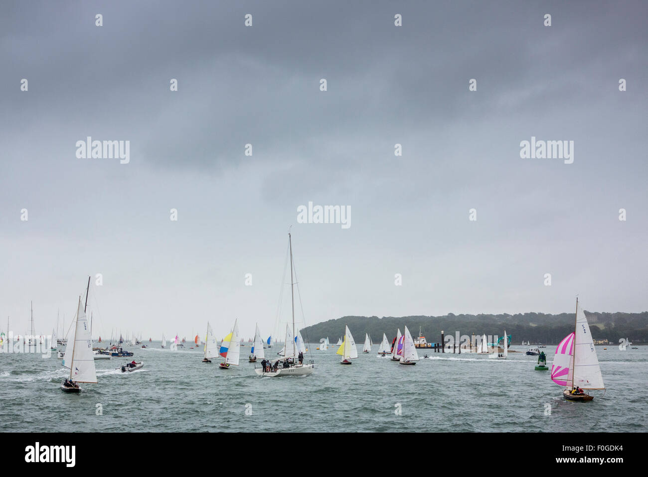 Scenes from Cowes Week on the Isle of Wight, England - yachts race under a very dark, leaden, cloudy, stormy sky Stock Photo