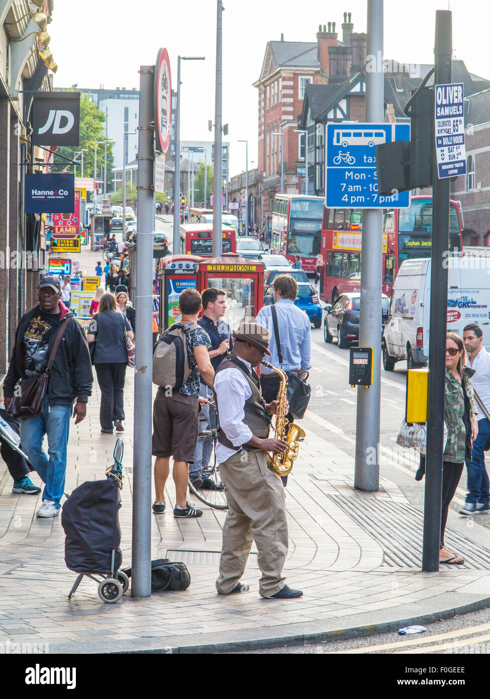 A saxophonist busks in the streets of London Stock Photo