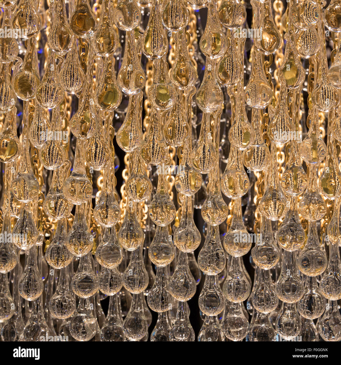 Backlit teardrop shaped glass beads of a chandelier glow at a lamp shop in the Grand Bazaar, Istanbul, Turkey. Stock Photo