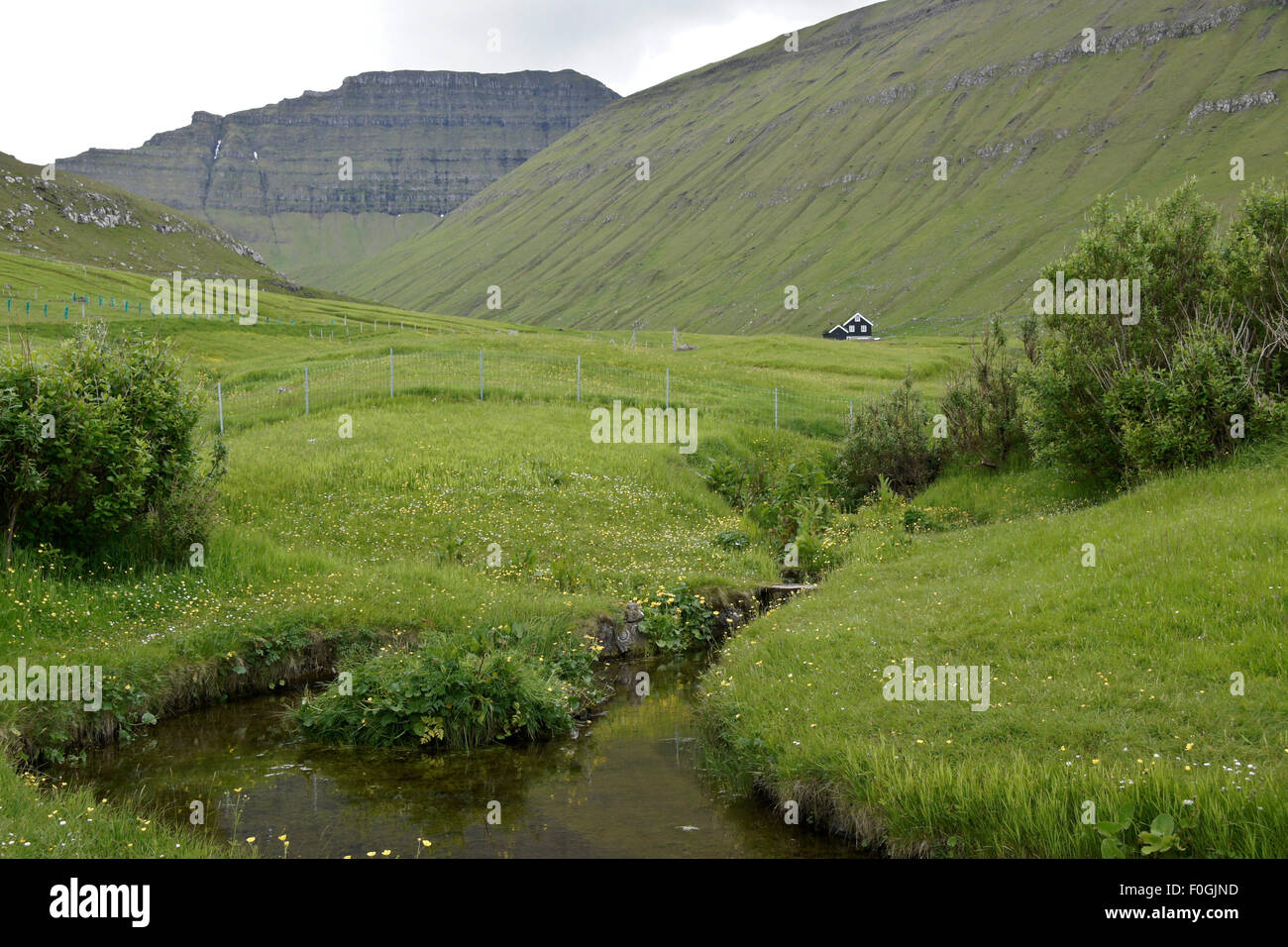 Lone house at foot of mountain near village of Gjogv, Eysturoy, Faroe Islands Stock Photo