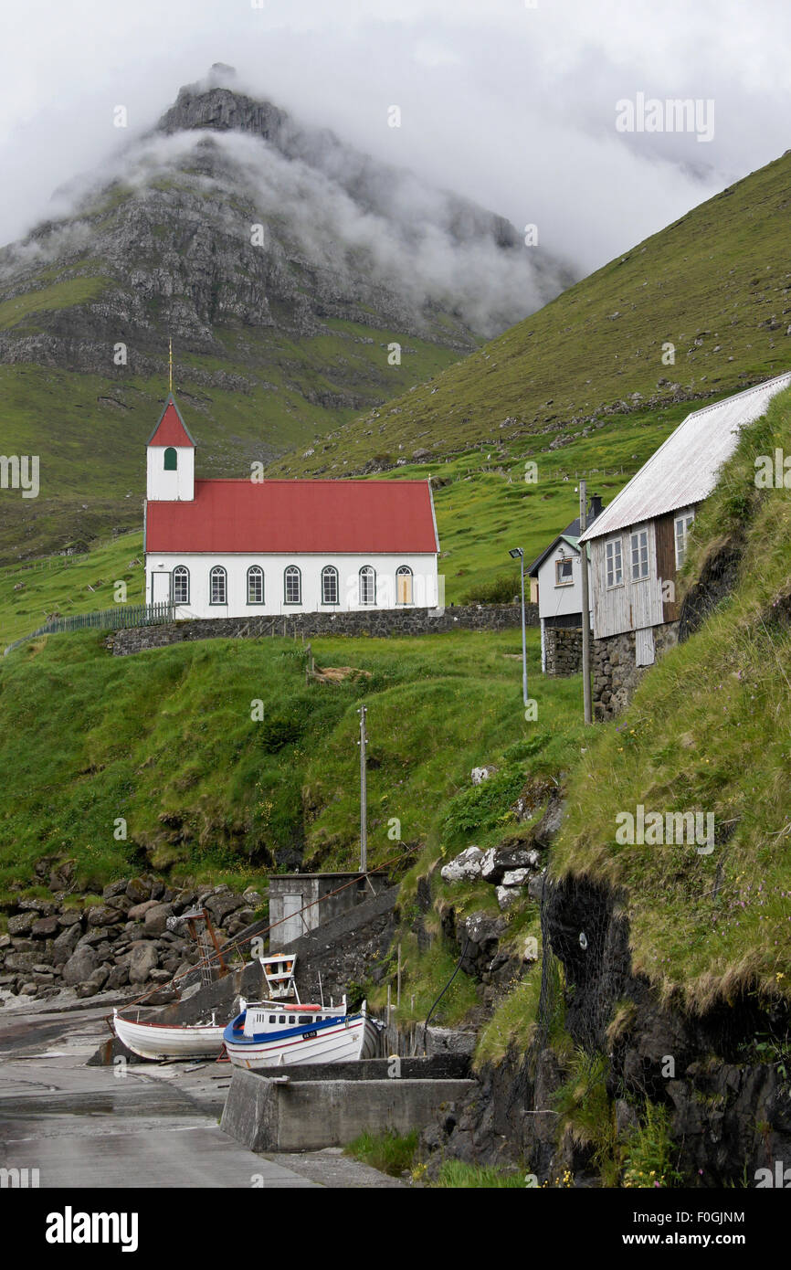 Church and boats, village of Kunoy, Kunoy Island, Faroe Islands Stock Photo