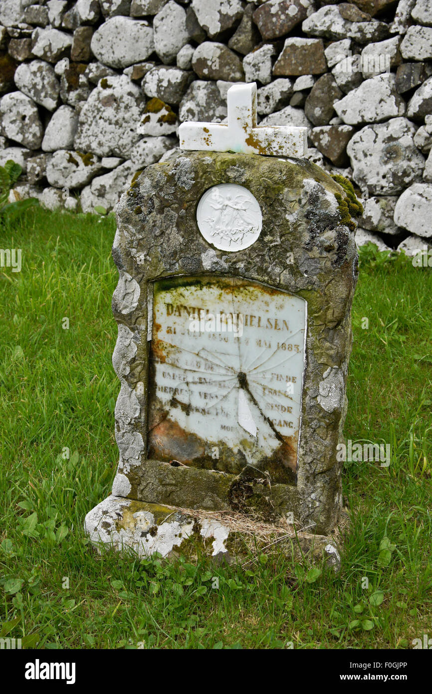 Old tombstone in church graveyard, village of Kirkjubour, Stremoy, Faroe Islands Stock Photo