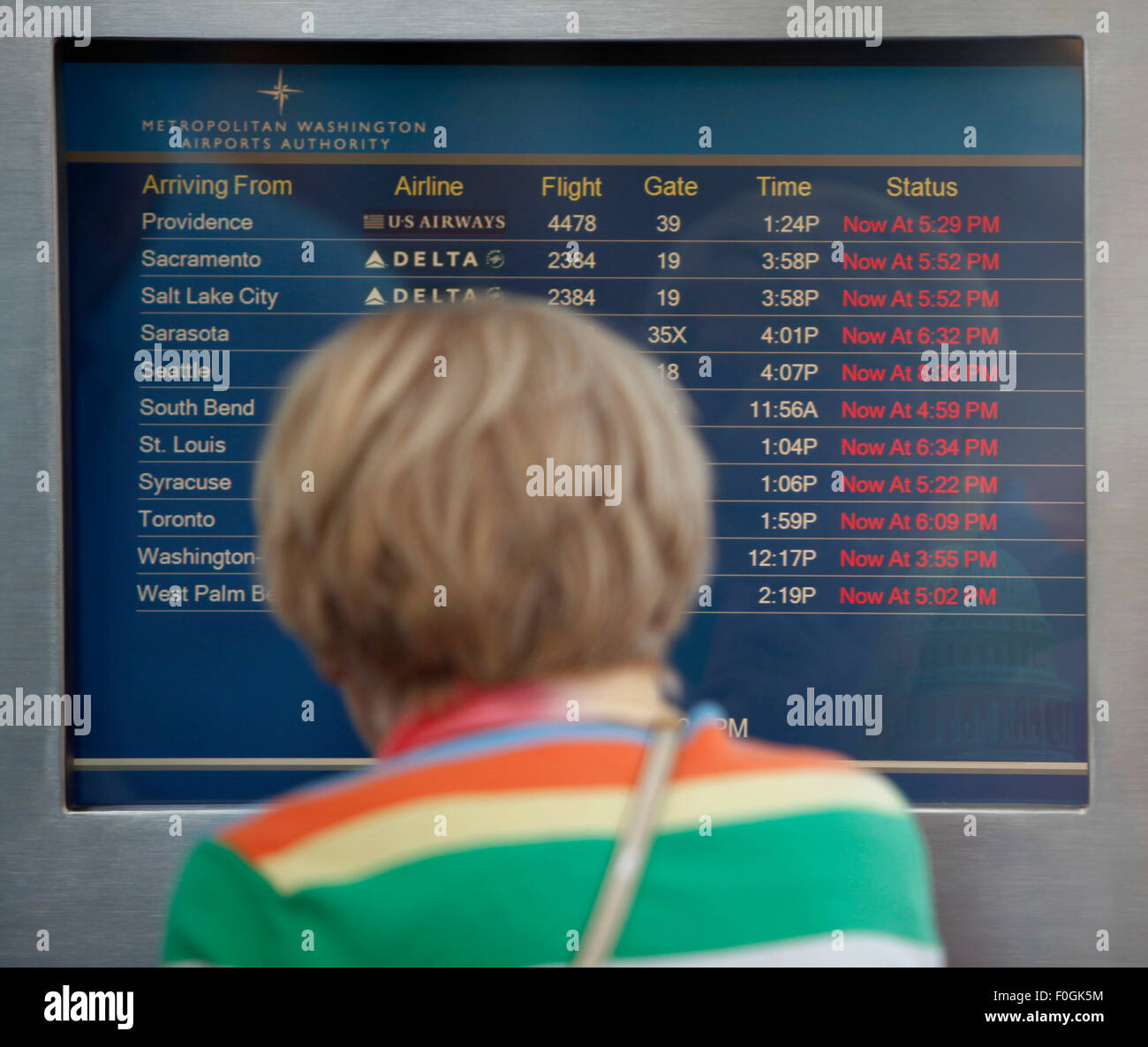 Washington, DC, USA. 15th Aug, 2015. A passenger checks the latest flight information at Ronald Regan National Washington Airport in Washington, DC, the United States, on Aug. 15, 2015. Computer malfunction at an air traffic control center in Virginia near Washington, DC was delaying arrivals and departures for flights in the U.S northeast, the Federal Aviation Administration (FAA) said Saturday. © Liu Shuai/Xinhua/Alamy Live News Stock Photo