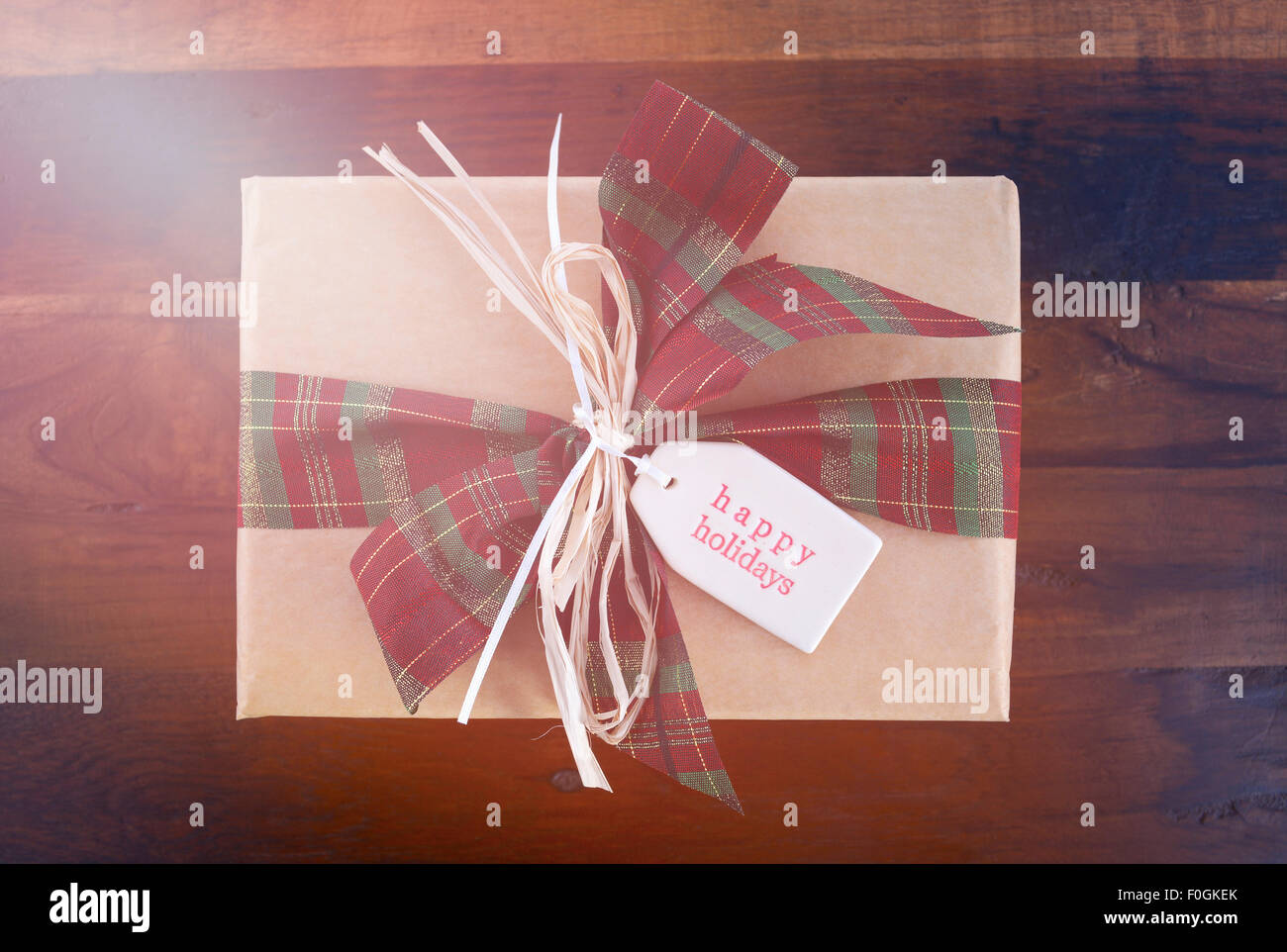 Vintage style Christmas gift on dark wood background with added retro