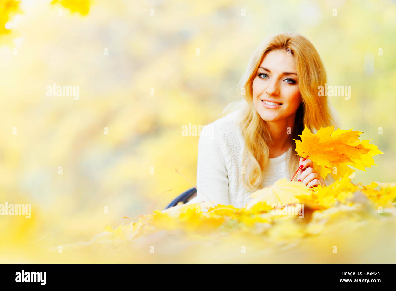 Woman laying in autumn park Stock Photo - Alamy