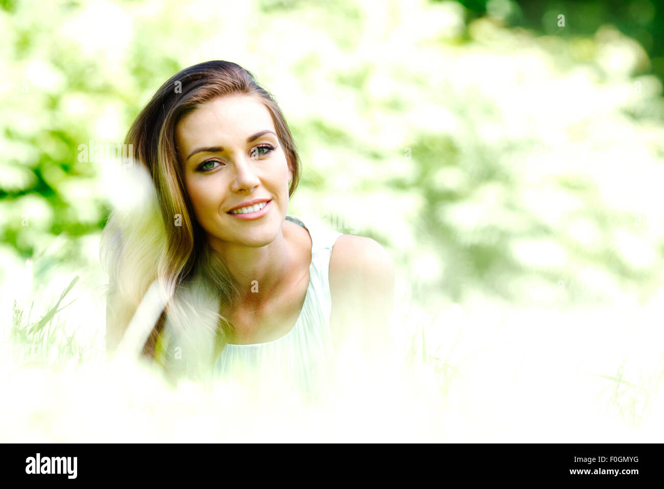 young woman in blue dress lying on grass Stock Photo - Alamy