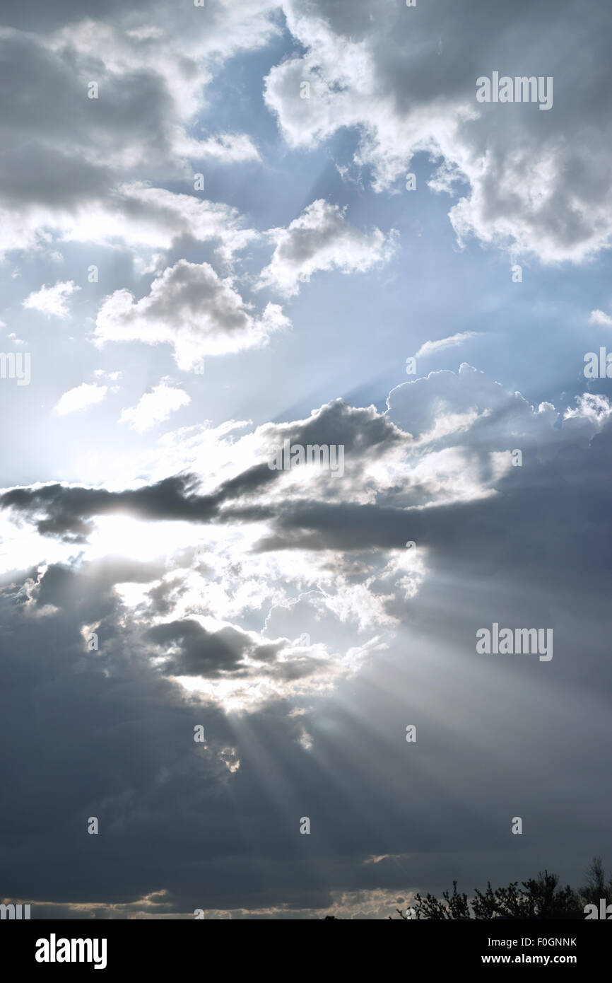 Clouds against blue sky and light rays Stock Photo