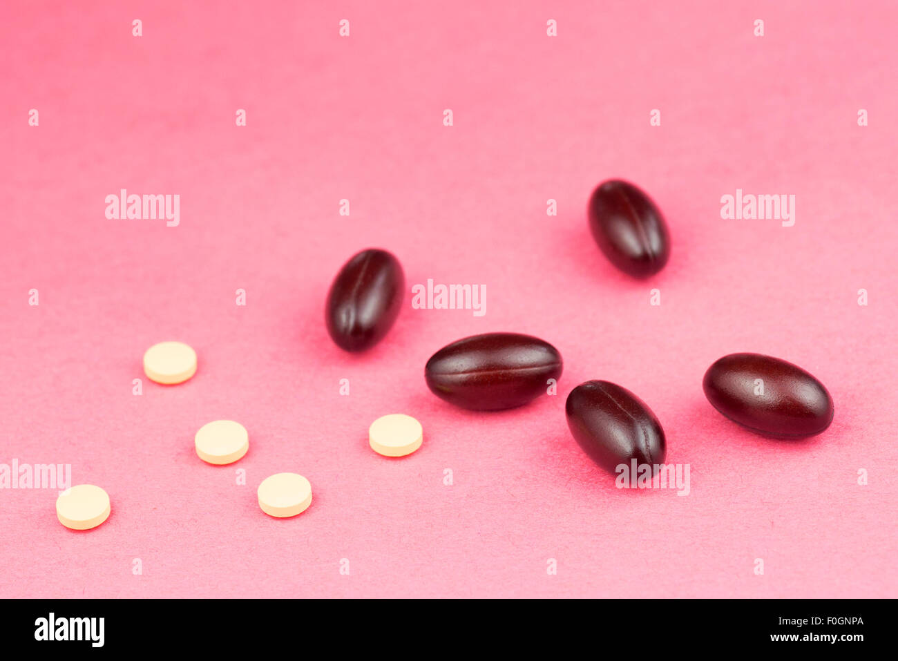 Statin tablets and Coenzyme Q10 softgel capsules - - conventional and alternative medicine Stock Photo