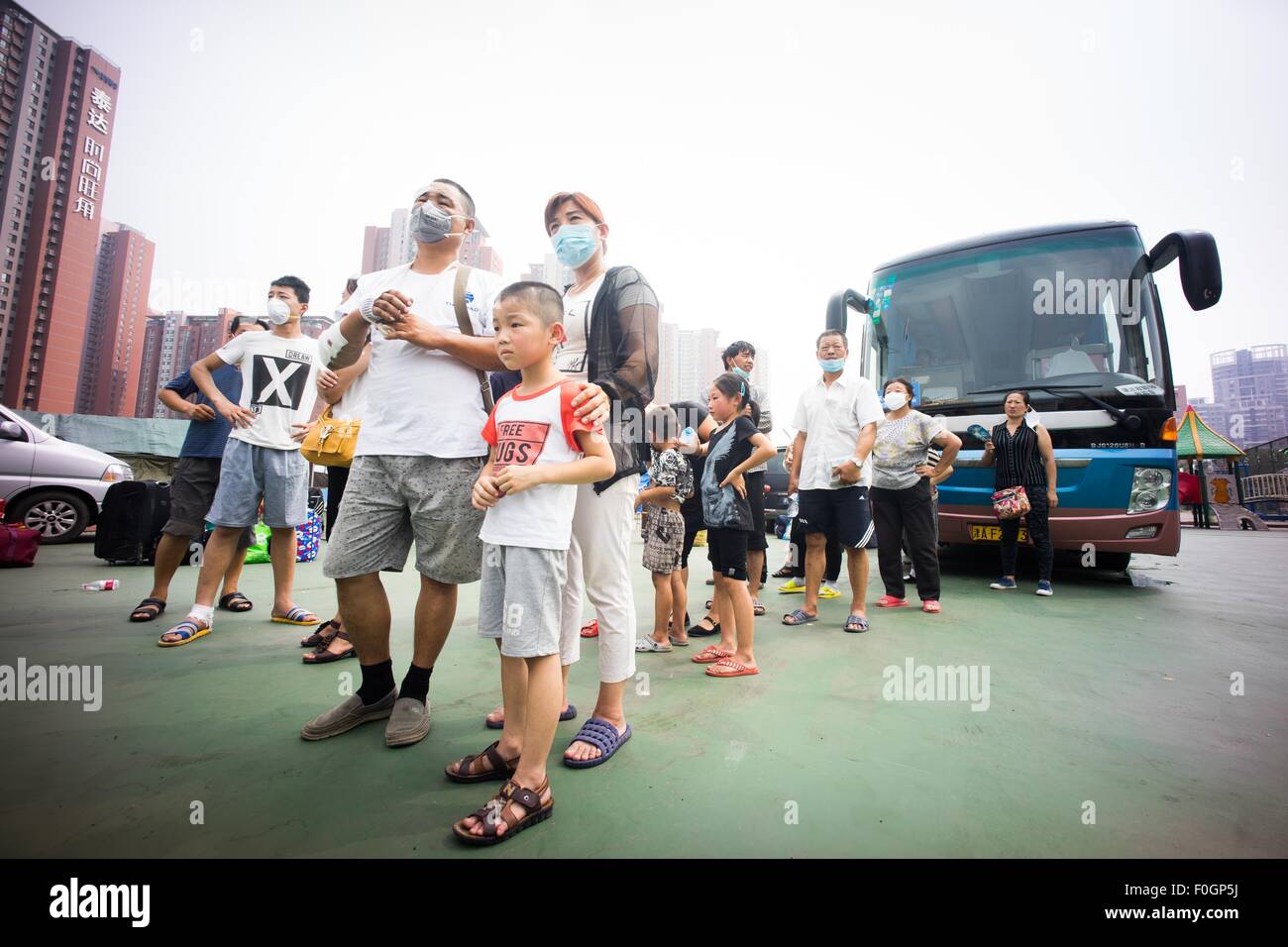 China. 15th Aug, 2015. Refugees waiting to board the bus to be evacuated from the temporary refugees camp as local authority confirmed there are toxic gas in the surrounding area of the blast. The death toll has risen to 104. Local authority starts to evacuate local residents from the temporary camp located at a local school near the blast zone as they extend the exclusion zone to 3 km from where the explosion happened as poison air which could cause cancer is being detected. © Geovien So/Pacific Press/Alamy Live News Stock Photo