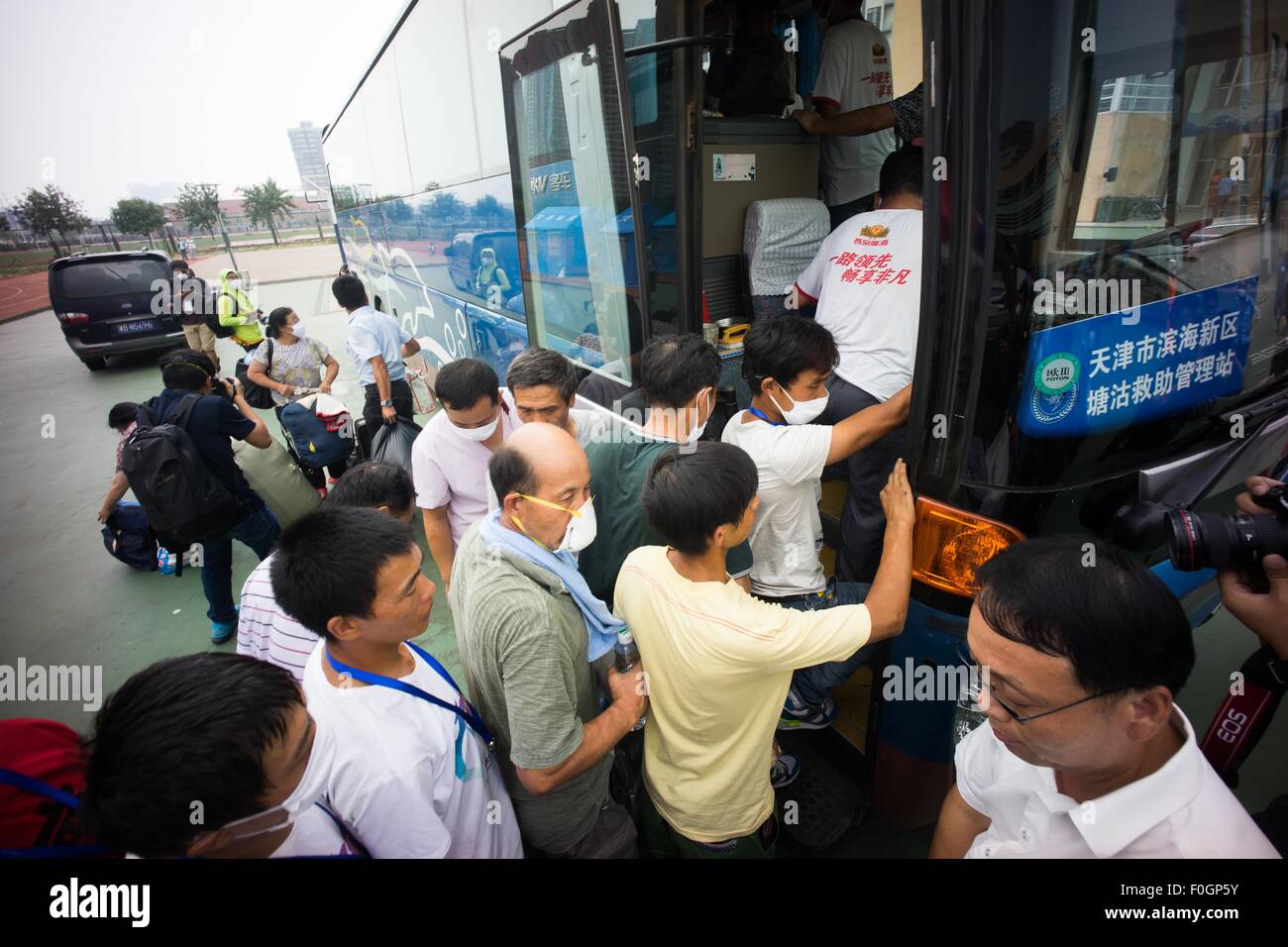 China. 15th Aug, 2015. Refugees boarding the bus to evacuat from the temporary refugees camp as local authority confirmed there are toxic gas in the surrounding area of the blast. The death toll has risen to 104. Local authority starts to evacuate local residents from the temporary camp located at a local school near the blast zone as they extend the exclusion zone to 3 km from where the explosion happened as poison air which could cause cancer is being detected. © Geovien So/Pacific Press/Alamy Live News Stock Photo
