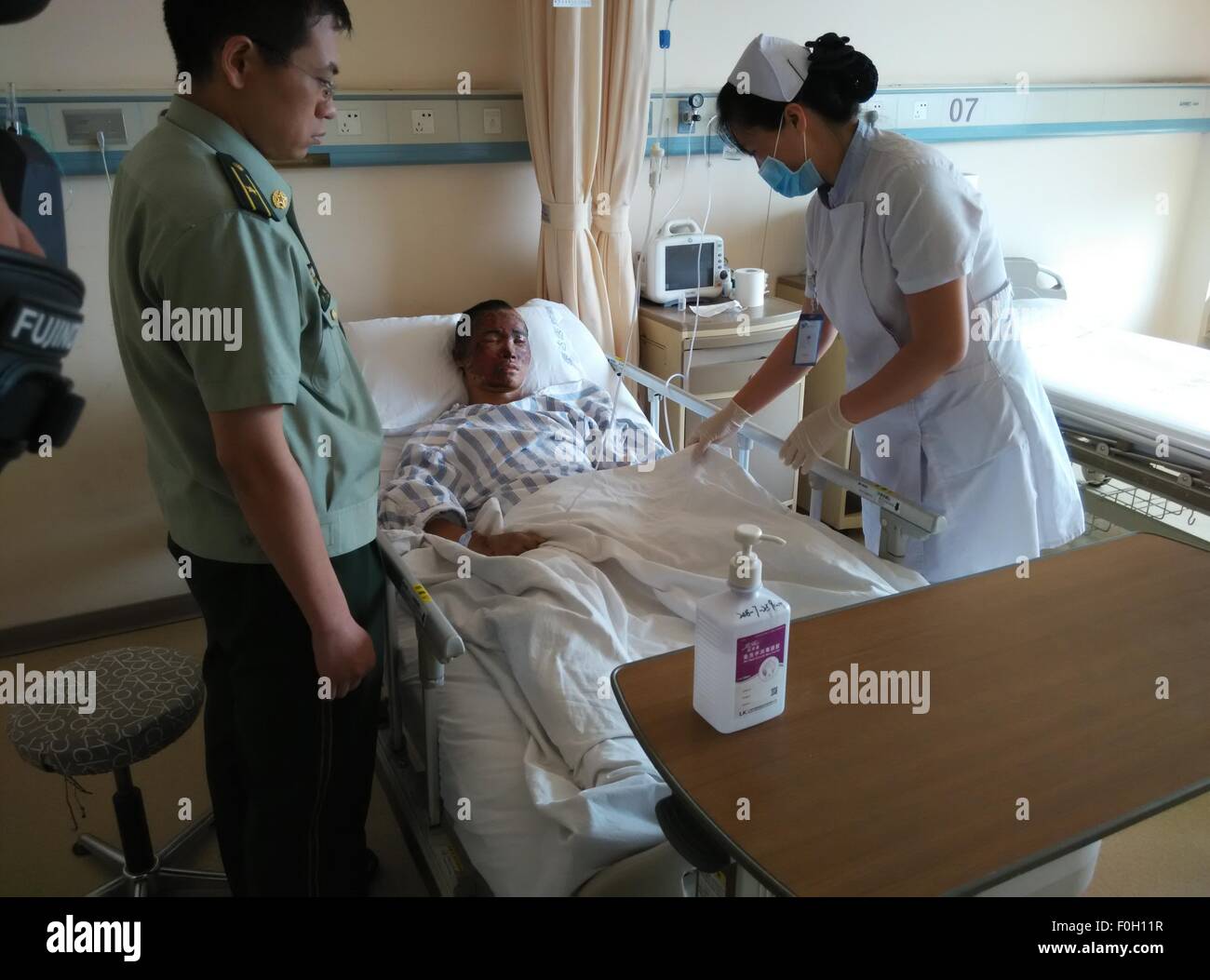 Tianjin. 16th Aug, 2015. A nurse takes care of the rescued firefighter Zhou Ti in Taida Hospital in north China's Tianjin Municipality, Aug. 16, 2015. Zhou has recovered smoothly and can have slop for food on Sunday. © Lv Dong/Xinhua/Alamy Live News Stock Photo