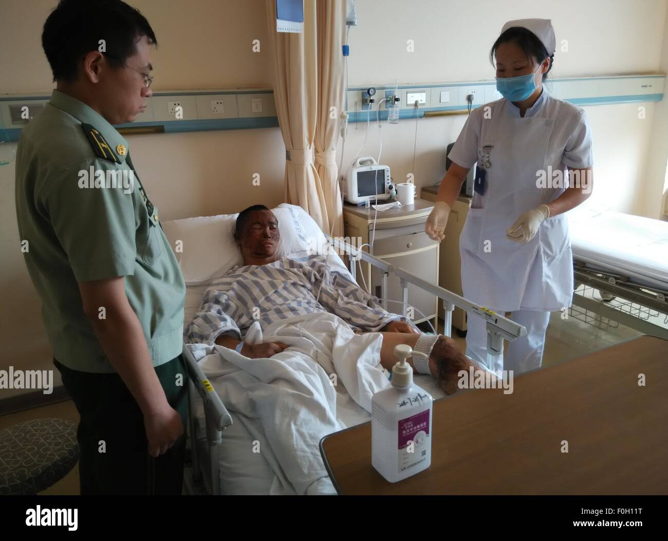 Tianjin. 16th Aug, 2015. A nurse takes care of the rescued firefighter Zhou Ti in Taida Hospital in north China's Tianjin Municipality, Aug. 16, 2015. Zhou has recovered smoothly and can have slop for food on Sunday. © Lv Dong/Xinhua/Alamy Live News Stock Photo