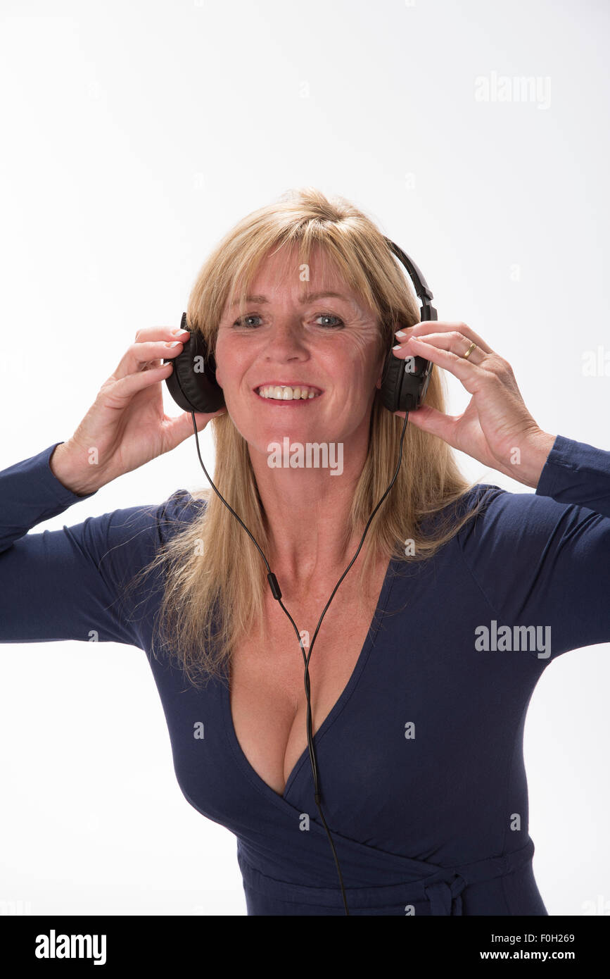 Attractive woman holding headphones to her ears Listening to music