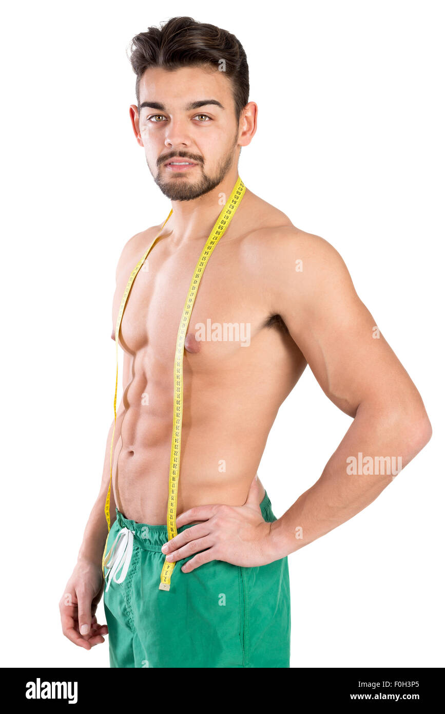 Muscular sports man tries to measure his neck muscles with measuring tape  isolated over gray background. Confused bodybuilder holding tape measure.  Stock Photo