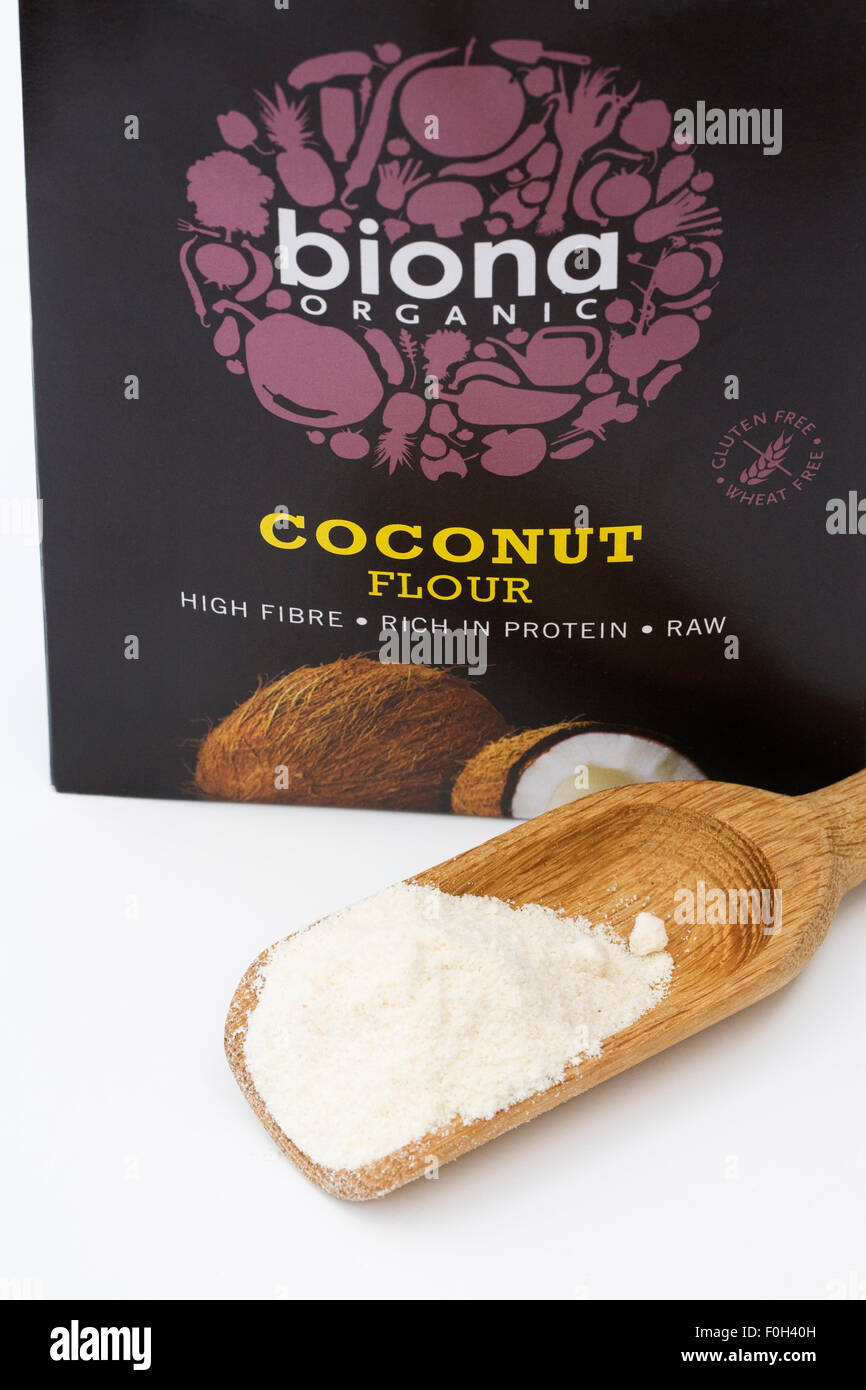 Coconut flour in a wooden scoop. Stock Photo
