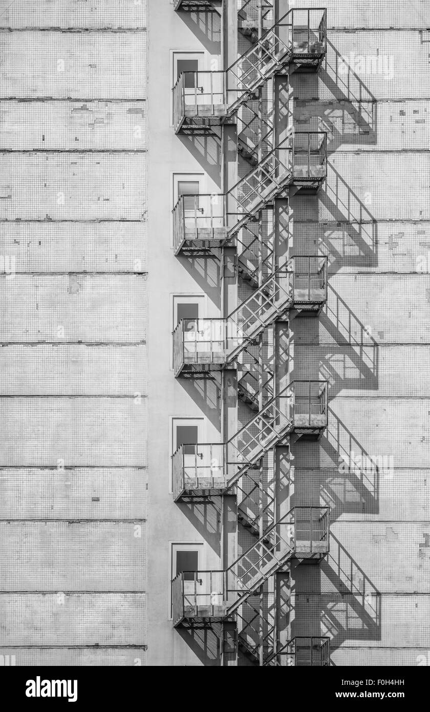 Monochrome image of the exterior of a building with old fire escape. Stock Photo