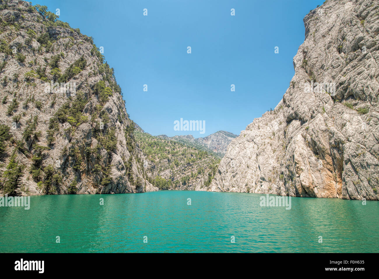 Rocky island green canyon in a mountain lake , Turkey Stock Photo