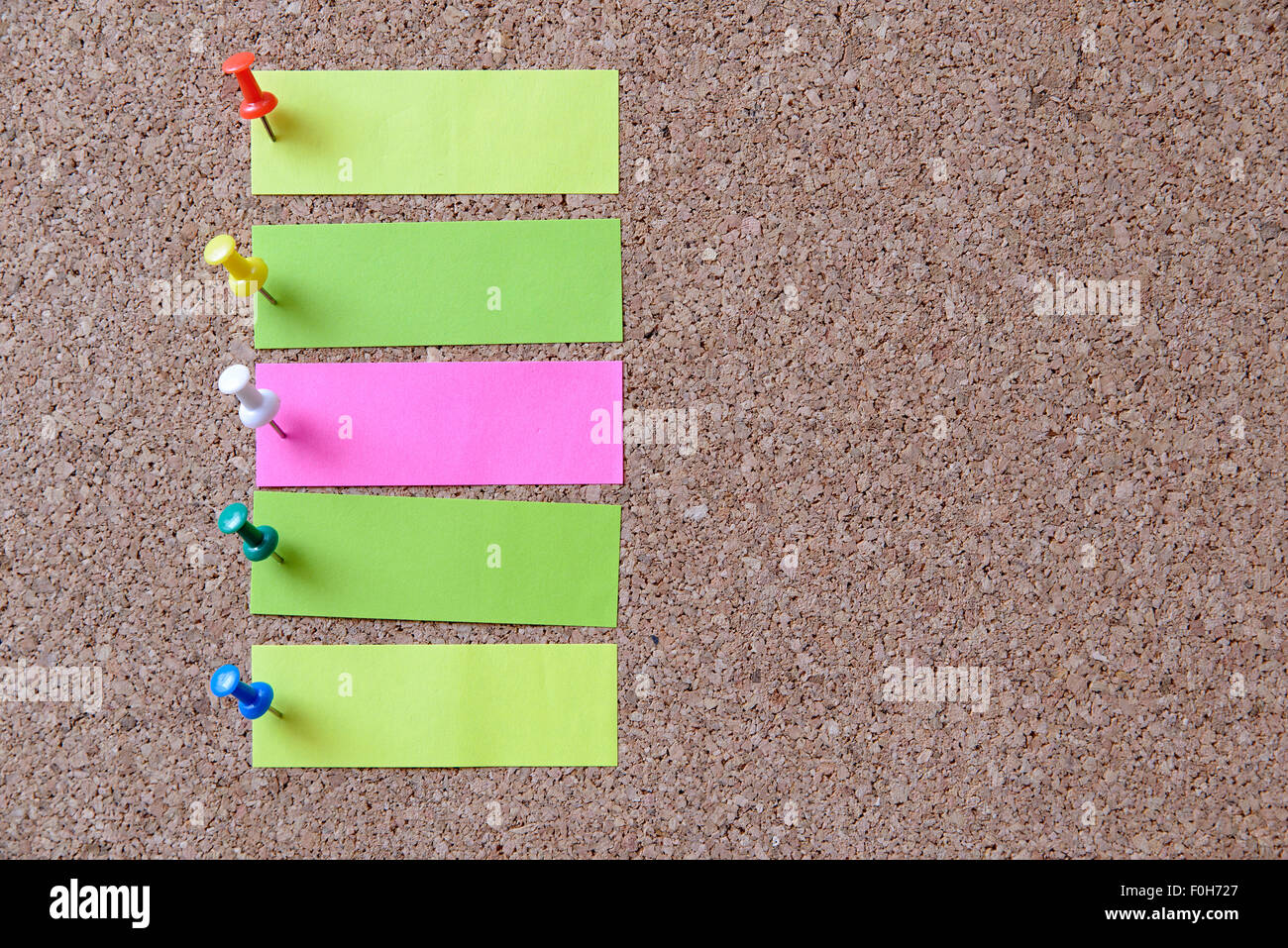 five color note on corkboard Stock Photo - Alamy