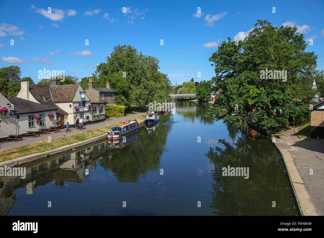 Canal boats on river Canal boats and barges tied up along the Cam River, Cambridge, England. Stock Photo