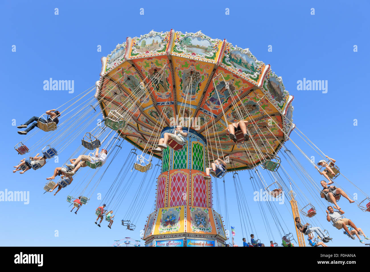 People ride the Wave Swinger at the Ohio State Fair in Columbus, Ohio. Stock Photo