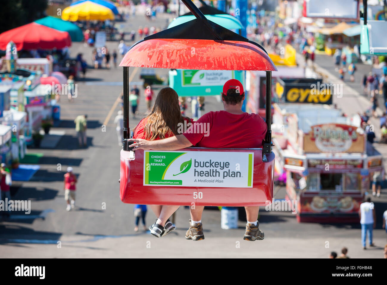 A couple enjoys the view from the Sky Glider high over the midway at the Ohio State Fair in Columbus, Ohio. Stock Photo