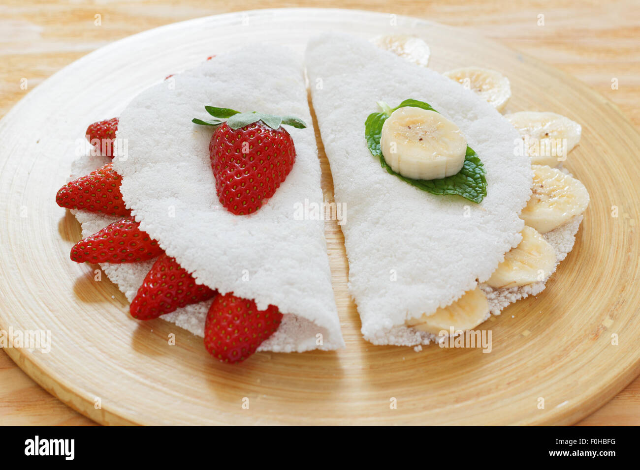 Casabe (bammy, beiju, bob, biju) - flatbread made from cassava (tapioca) with strawberry and banana. Selective focus Stock Photo