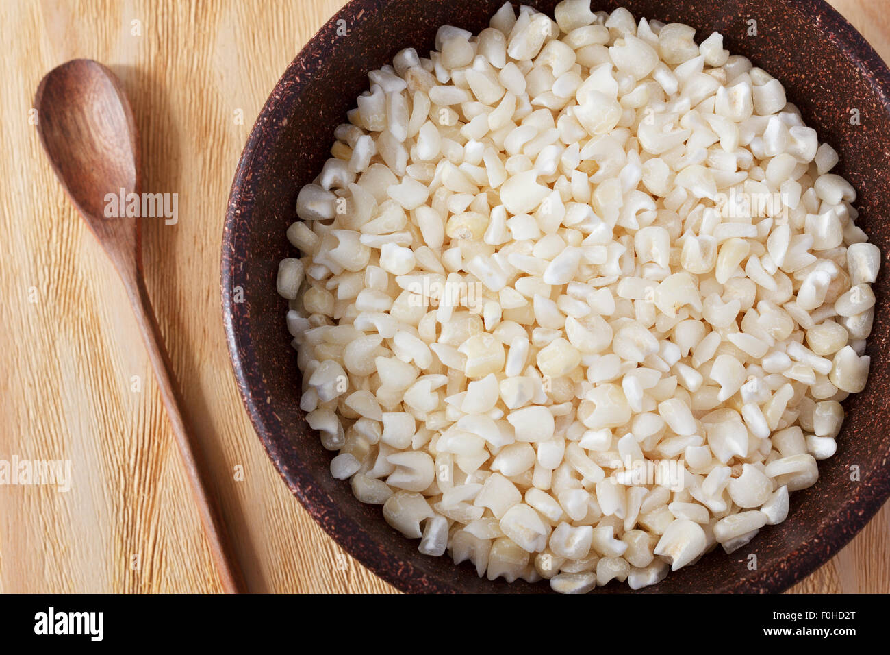 White grated corn kernels in brown bowl. Selective focus Stock Photo