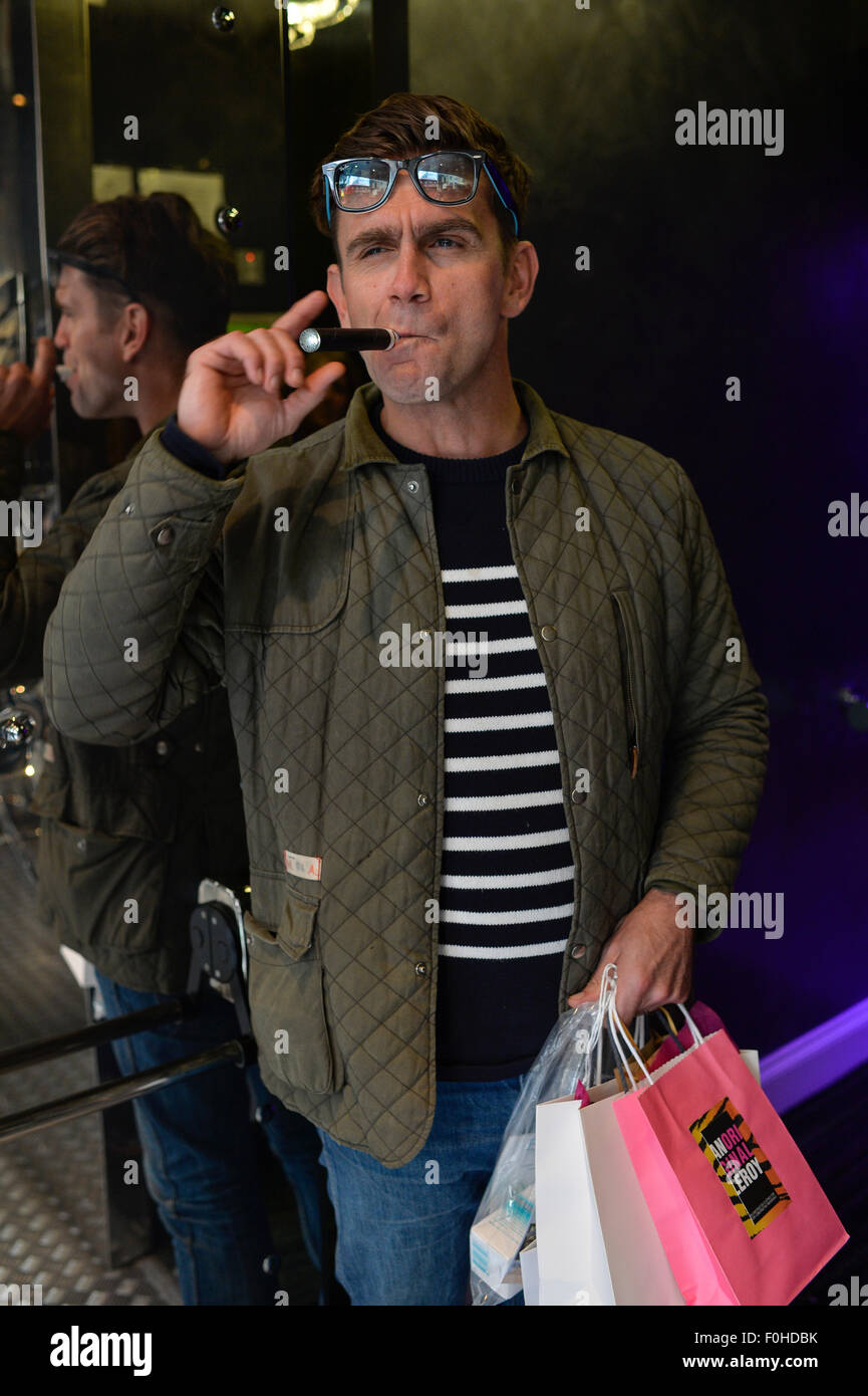 Actor Scott Maslen smoking an electronic cigarette in doorway. Stock Photo