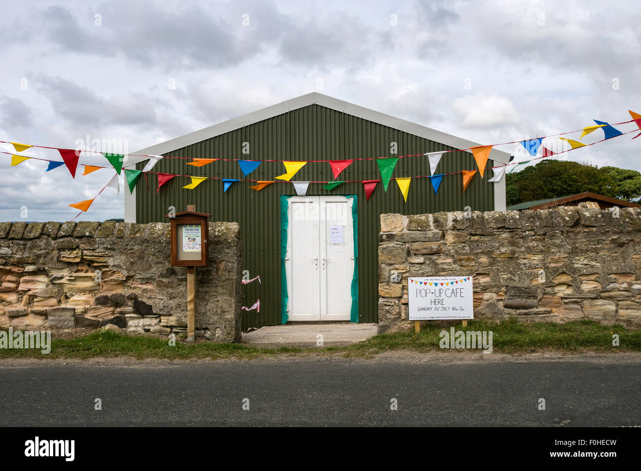 Village hall at Boulmer in Northumberland with sign advertising a pop-up cafe. Stock Photo