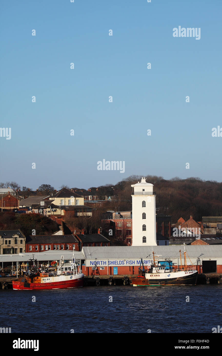 The fish market be the harbour in North Shields, England. The Low Light tower stands by the dock. Stock Photo