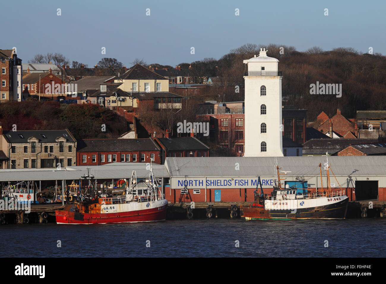 The fish market be the harbour in North Shields, England. The Low Light tower stands by the dock. Stock Photo