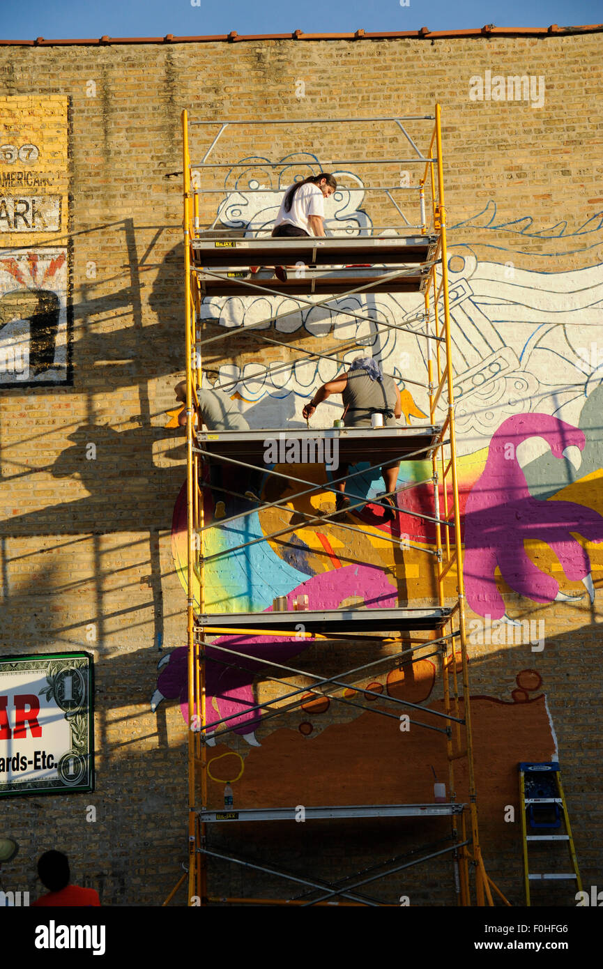Mexican artists painting mural named 'Monstruo de Rogers Park, Adelante' Stock Photo