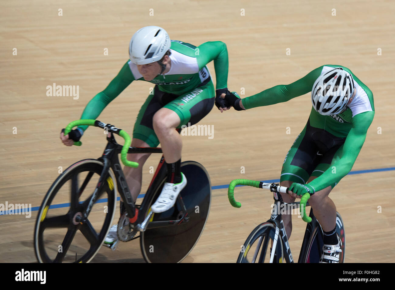 Derby, UK. 16th Aug, 2015. The Irish pair of Mark Downey and Fintan Ryan conduct a handsling changeover during the madison event at the Revolution Series at Derby Arena, Derby, United Kingdom on 16 August 2015. The Revolution Series is a professional track racing series featuring many of the world's best track cyclists. This event, taking place over 3 days from 14-16 August 2015, is an important preparation event for the Rio 2016 Olympic Games, allowing British riders to score qualifying points for the Games. Credit:  Andrew Peat/Alamy Live News Stock Photo