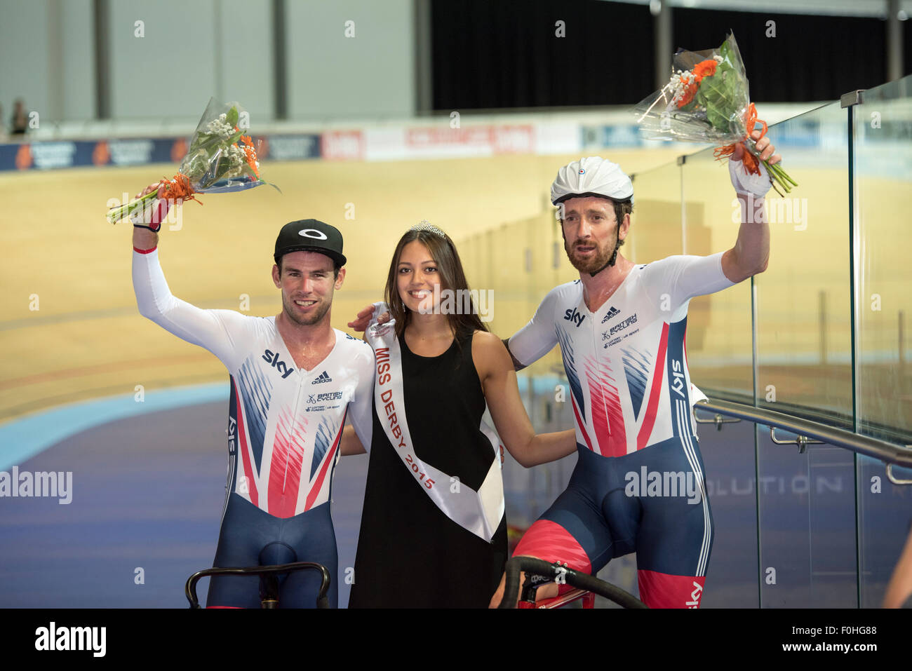 Derby, UK. 16th Aug, 2015. Sir Bradley Wiggins (left) and Mark Cavendish are pictured with Miss Derby following their victory in the madison at the Revolution Series at Derby Arena, Derby, United Kingdom on 16 August 2015. The Revolution Series is a professional track racing series featuring many of the world's best track cyclists. This event, taking place over 3 days from 14-16 August 2015, is an important preparation event for the Rio 2016 Olympic Games, allowing British riders to score qualifying points for the Games. Credit:  Andrew Peat/Alamy Live News Stock Photo
