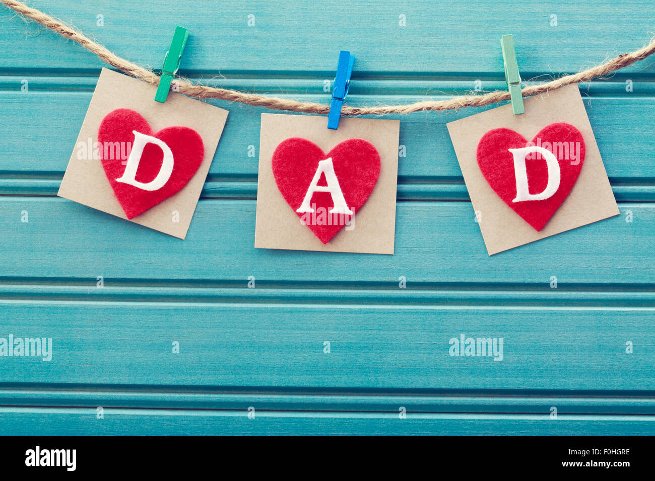 Fathers day message on felt hearts over blue wooden board Stock Photo