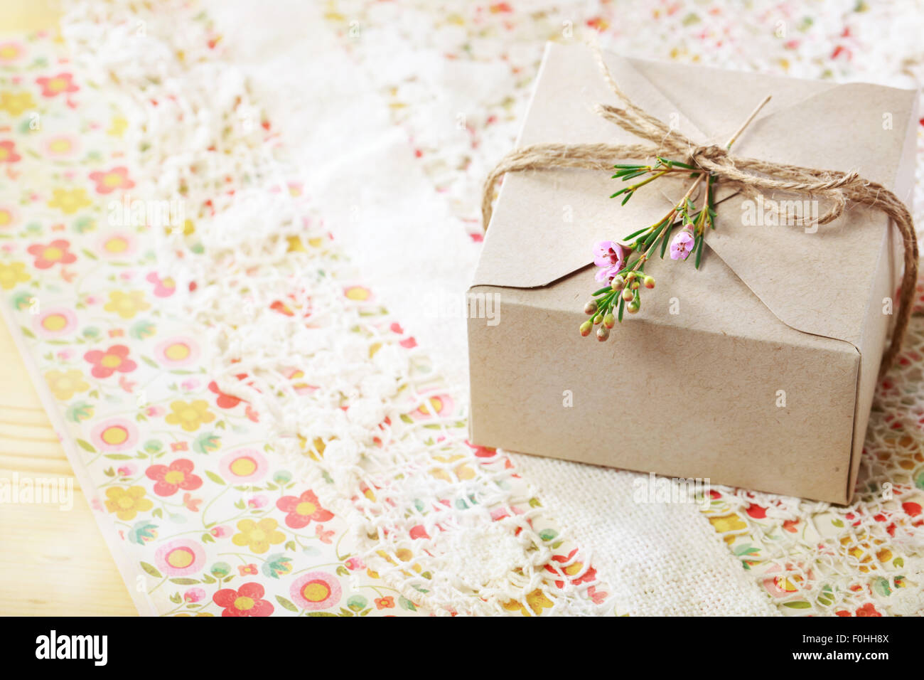 Hand crafted card stock present box with wax flowers Stock Photo