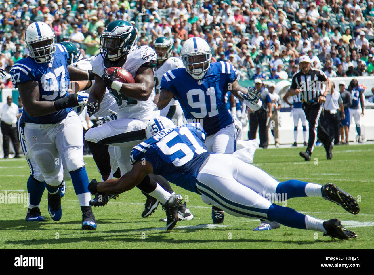 Philadelphia, Pennsylvania, USA. 16th Aug, 2015. Philadelphia Eagles running back Kenjon Barner (34) runs with the ball on his way to a touchdown while surrounded by Indianapolis Colts, defensive end Arthur Jones (97), linebacker Henoc Muamba (51) and outside linebacker Jonathan Newsome (91) during the NFL game between the Indianapolis Colts and the Philadelphia Eagles at Lincoln Financial Field in Philadelphia, Pennsylvania. Christopher Szagola/CSM/Alamy Live News Stock Photo