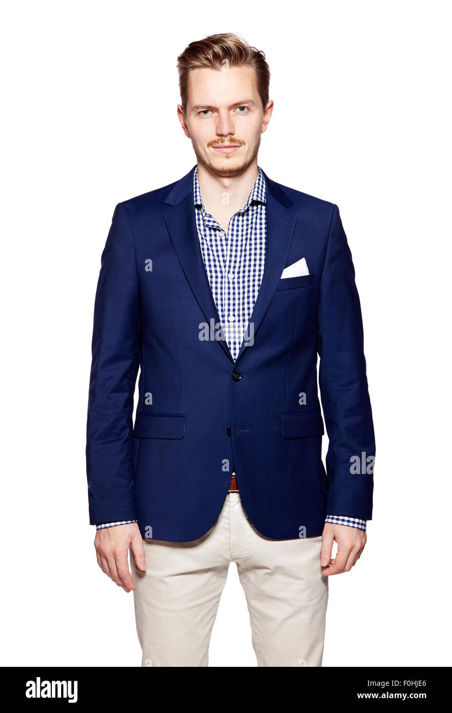 Portrait of a young businessman standing against isolated white ...