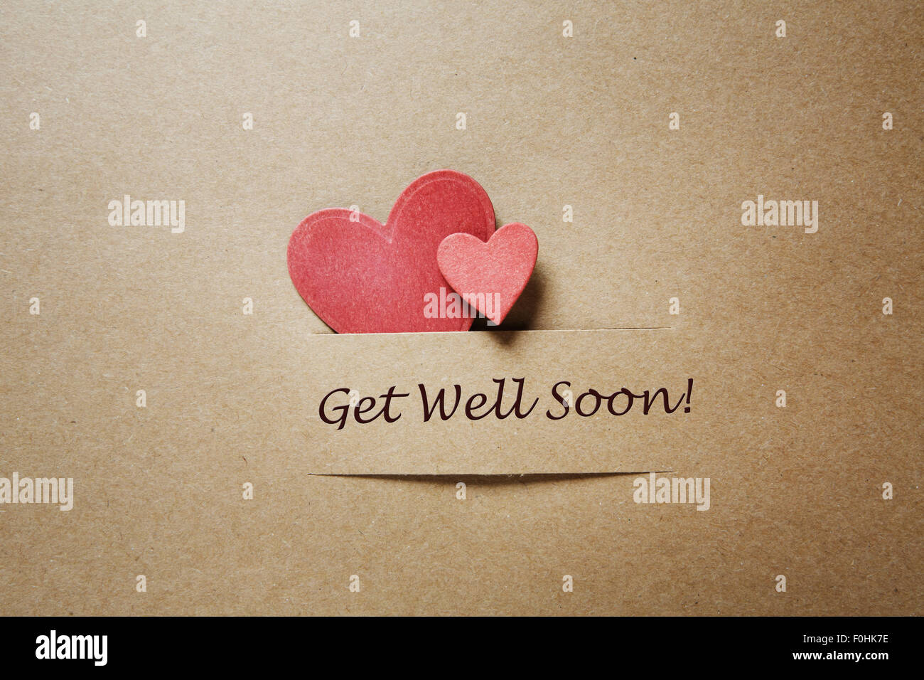 Get Well Soon message with red paper hearts Stock Photo