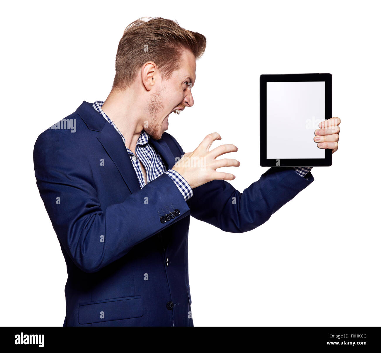 Studio shot of a angry young man is showing something on a digital ...